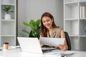 Work Online and Document Review. A young professional highlights documents with satisfaction while immersed in remote work. photo