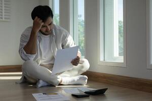 Stressed and headache man with large bills or invoices no money to pay to expenses and credit card debt. shortage, Financial problem, bankruptcy, mortgage, loan, bankrupt, poor empty wallet photo