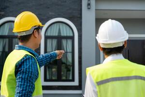 inspector engineer project is inspecting construction and quality assurance new house. Engineers or architects or contactor work to build the house before handing it over to the homeowner photo