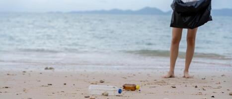 Save water. Volunteer pick trash garbage at the beach and plastic bottles are difficult decompose prevent harm aquatic life. Earth, Environment, Greening planet, reduce global warming, Save world photo