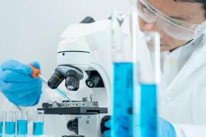 Scientist analyze biochemical samples in advanced scientific laboratory. Medical professional use microscope look microbiological developmental of viral. Biotechnology research in science. photo