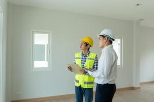 inspector engineer and owner project is inspecting construction and quality assurance new house. Engineers or architects or contactor work to build the house before handing over to the homeowner. photo