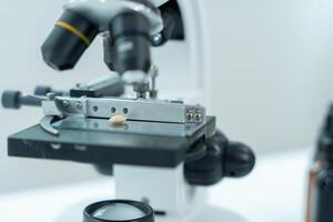 Scientist analyze biochemical samples in advanced scientific laboratory. Medical professional use microscope look microbiological developmental of viral Biotechnology research in science lab, photo