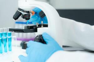 Scientist analyze biochemical samples in advanced scientific laboratory. Medical professional use microscope look microbiological developmental of viral. Biotechnology research in science lab, photo
