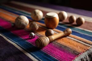 Close-up of traditional Latin American percussion instruments on colorful woven textile photo