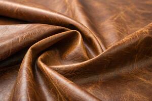 Close up view of brown leather with natural texture and folds in a studio setting for design elements photo