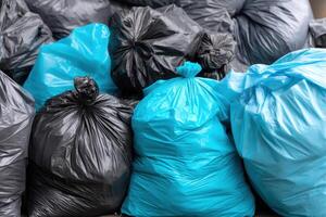 Heap of Black and Blue Garbage Bags in Outdoor Setting photo