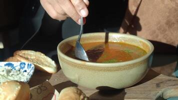 Enjoying flavorful soup in a cozy setting at noon video