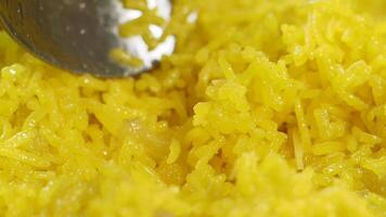 Savoring aromatic yellow rice prepared with spices and herbs video