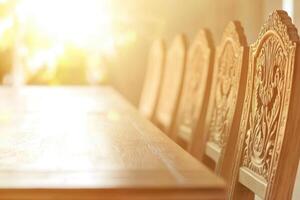 Sunlight illuminates ornate wooden chairs and table photo