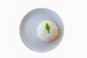 Rice on a white ceramic plate with empty space for design work. Soft and selective focus photo