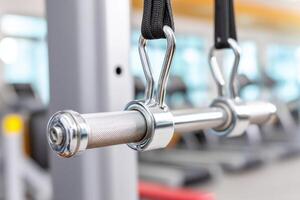 Close-up of lat pulldown bar hanging in modern gym photo