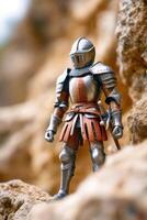 Medieval knight action figure standing on rocks in a blurred background photo