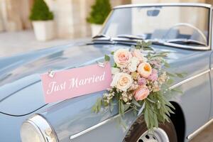 Vintage car adorned with flowers and a sign celebrating a wedding, symbolizing love and joy in a romantic setting, perfect for wedding themes and celebrations concept photo