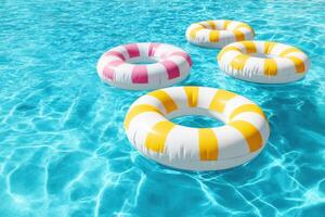 Colorful inflatable pool rings floating in clear blue water creating a vibrant summer atmosphere ideal for relaxation and fun water activities concept photo