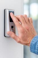 Hand pressing modern smart doorbell with digital interface for home security system and convenience technology concept photo