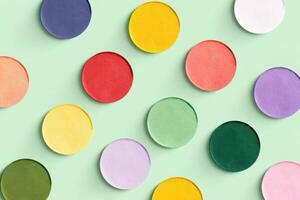 Colorful circular paper cutouts arranged artistically on a soft green background showcasing vibrant hues and textures for creative voting concept photo