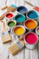 Vibrant collection of paint cans with assorted colors and brushes arranged on rustic wooden surface showcasing creativity and artistic expression in home improvement projects photo
