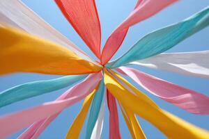 Stock image of a traditional maypole decorated with colorful ribbons fluttering in the spring breeze, bright blue sky background, creating a dynamic and festive atmosphere of celebration and joy photo