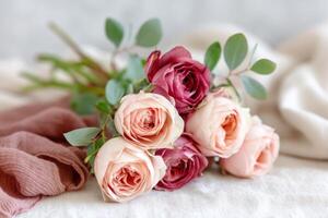 Bouquet of delicate roses in soft pastel colors arranged on a textured surface, showcasing natural beauty and elegance in floral design and composition photo