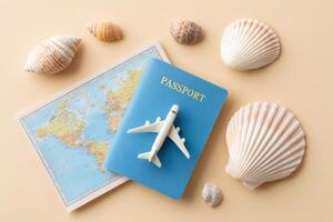 Travel essentials arranged on a soft pastel background featuring a blue passport, a miniature airplane, a world map, and various seashells evoking wanderlust and adventure photo