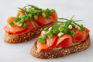 Delicious open-faced sandwich topped with smoked salmon, fresh green onions, and herbs on a rustic brown bread, showcasing vibrant colors and appetizing presentation photo