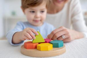 Child engaged in autism occupational therapy session, playing with colorful geometric shapes on a wooden board, fostering cognitive skills and sensory development in a nurturing environment photo