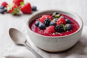 Amaranth porridge with fresh berries and sesame seeds in a bowl photo