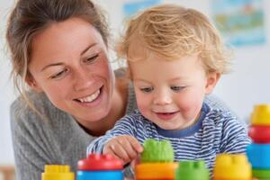 Child engaged in autism occupational therapy session with a smiling caregiver, playing with colorful building blocks, fostering development and learning through interactive play photo