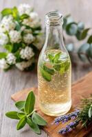 Sparkling herbal elixir with sage and lemon balm on wooden table photo