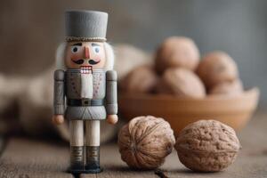 Wooden nutcracker figurine stands beside whole walnuts on rustic wooden table, with a bowl of shelled nuts in the background, creating a cozy seasonal atmosphere photo