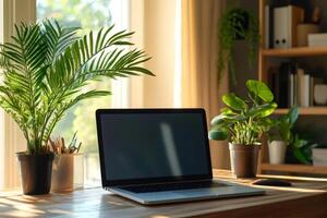 Laptop showing empty screen sitting on wooden desk at home with plants photo