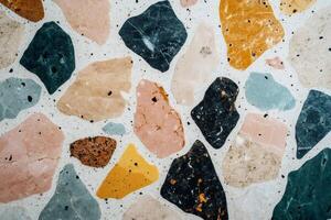 Colorful terrazzo flooring pattern showing various stone fragments embedded in concrete photo