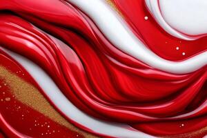 Red and white paint mixing with gold glitter, creating a luxurious swirling pattern photo