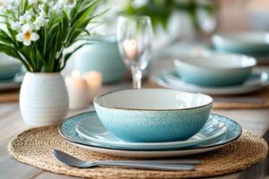 Stylish dinnerware set with decorative flowers and candles creating cozy ambiance on dining table photo