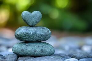 Heart shaped rock balancing on stack of stones symbolizing love and harmony photo
