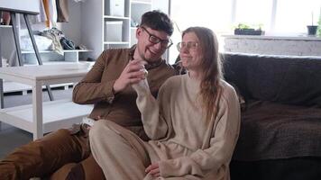 couple playing games using controller at home, having fun video