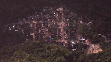 an aerial view of a small village in the middle of the forest video