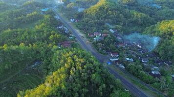 Road in the middle of the hill, construction of a bend in the road towards the mountain, the concept of a rainforest ecosystem and healthy environment video