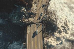 Aerial image of a collapsed highway over crashing ocean waves. Broken infrastructure, stranded vehicles, and debris reflect the power of natural disasters and the vulnerability of coastal regions. photo
