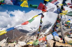 Prayer flags pole on the top of Tsergo Ri the high point on the Langtang valley trek of Nepal. photo