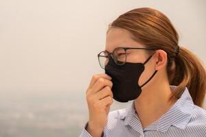 Businesswoman coughing becaused of allergy from Bad air pollution. photo