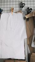 Tailoring patterns and scissors hanging in sewing studio video