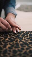 Marking fabric with chalk on leopard print textile video