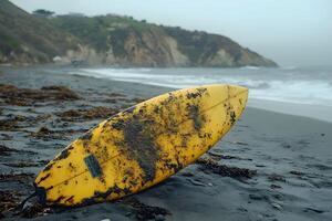 Surfboard on Misty Beach with Rocky Cliffs and Overcast Sky - Coastal Adventure Concept photo