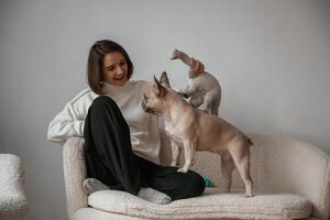 Conception, of love and care. Young woman is with her pug dog at home photo