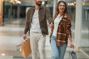 Guy don't want, to,, go for shopping. Young couple are in supermarket together photo
