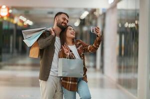 Making selfie. Young couple are in ,supermarket together photo