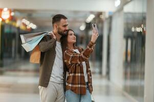 Making selfie. Young couple, are, in supermarket together photo