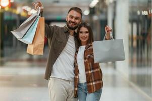 Shopping is finished. Young, couple are in supermarket together photo